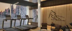 Stylish gym with treadmills overlooking a full-length window and snowy woodland, with a wood-panelled wall and a mural of a skiing figure