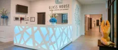 Modern reception desk with LED lighting and a Glass House sign