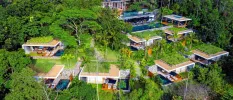Open-air villas staggered across a hillside in the jungle, with pools and loungers visible