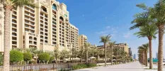Palm-line promenade next to the palatial exterior of Fairmont The Palm