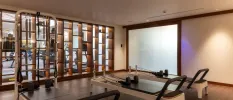 Reformer Pilates equipment in a chic studio with wooden furnishings and spotlights