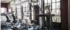 Gym equipment in a studio with large windows
