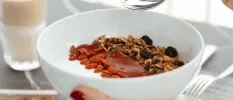 White bowl with yoghurt grains and a red sauce
