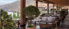 Smart looking restaurant with outdoor seating overlooking the beach and mountain 