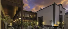 Illuminated exterior of Hacienda del Conde at night, showcasing warm lighting and traditional Spanish architecture in Tenerife