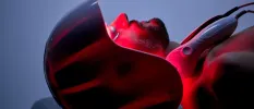 Man lies in a red light contraption in a treatment room