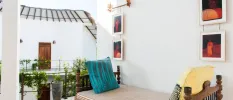Balcony with a cushioned sofa, and paintings depicting Sri Lankan people