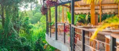 Elevated restaurant terrace suspended among tropical greenery
