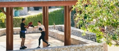 Lady is having a boxing class with a personal training on outdoor platform