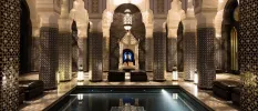 Indoor pool surrounded by decadent Arabian-style archways 