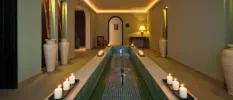 Tranquil spa treatment room at Hacienda del Conde, Tenerife, softly lit with glowing candles creating a serene ambiance