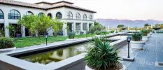 Concrete-framed ponds outside SANté Wellness Retreat & Spa, fringed by white plant pots and black lighting