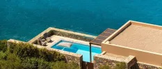 Low-rise villa with a seafront perch, with a private pool terrace, loungers and cobble-stone walls