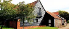 Black wooden exterior of The Detox Barn, Suffolk wellness retreat 