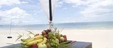 Fresh fruit piled up on a wooden table on Nadan Beach