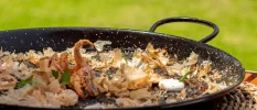 Large black pan with squid at the centre 