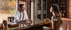 Guest having one on one consultation with resident Ayurvedic doctor in his office 