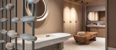 Wellness area with neutral walls, soft lighting, shell sculptures, a vanity unit and a wooden table with towels folded on it