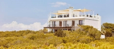 Exterior of Teranka Formentera, with its white walls, rooftop and surrounding greenery