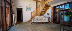 Traditional hallway with stone floors and a cosy sofa 