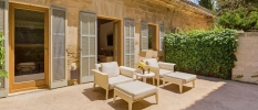 Outdoor terrace with white furniture and wall
