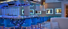 Central bar with blue lighting, blue stalls and a blue mural design