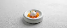 Dessert with edible flowers on a small white plate