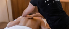 A person having a massage by a spa therapist dressed in a black t-shirt 