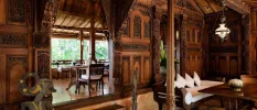 Restaurant with beautiful wood walls with intricate carvings and lanterns suspended from the ceiling