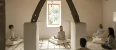 Group seated on cushions participating in a wellness class