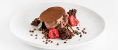 Chocolate mousse-like dessert topped with raspberries