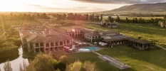 Aerial view of SANté Wellness Retreat & Spa, its two-storey sand-coloured buildings, outdoor pool and surrounding Winelands