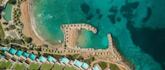 Aerial view of Porto Elounda Golf & Spa Resort, next to a dreamy blue sea