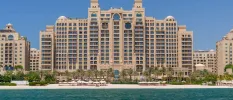 Palatial-looking sand-coloured exterior of Fairmont The Palm, on a white-sand beach right on the Dubai waterfront