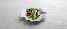 Dainty vegetables laid out on a small white plate