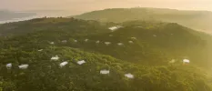 Villas peering out from forest-cloaked mountains