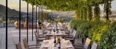 Leafy al fresco terrace with set tables and lovely views