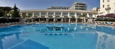Large swimming pool with an HP emblem at the bottom, standing for Hotel Palacio