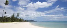 Nadan Beach, with its white sands, clear blue shallows and tropical greenery back
