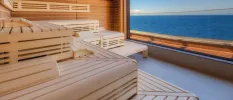 Wooden sauna with a large sea-view window