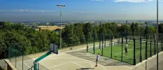 People in active wear enjoying the tennis and basketballs courts, next to the countryside