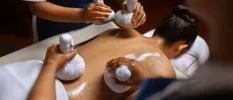Four hands ayurvedic massages using Ayurvedic oils and herbal pouches
