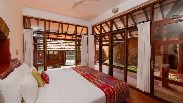 Authentic wooden huts with thatched roofs and stairs to an upper level