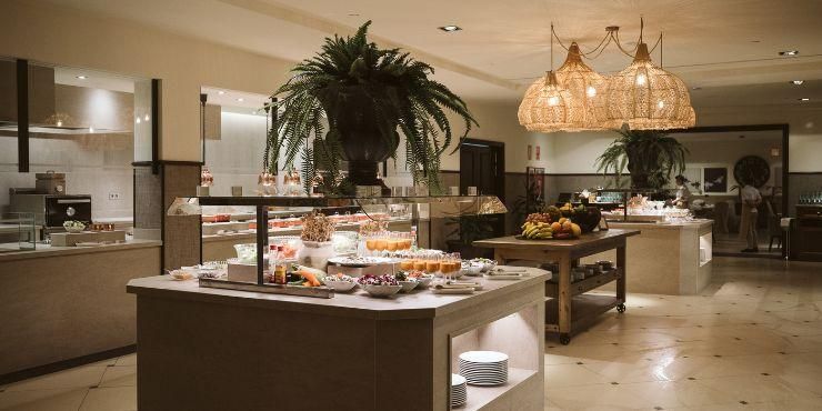 Buffet restaurant with glossy floors, food stations and rattan hanging lights
