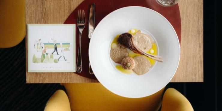 Gourmet food and a glass of white wine on a wooden table