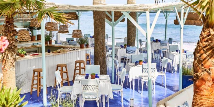 Wooden jetty jutting into the ocean with the words 'Marbella Club' above it